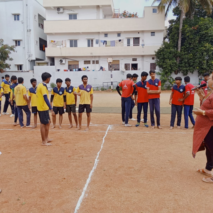 Students and physical education teacher in an outdoor sports ground session at Darsh Universal School, Hyderabad